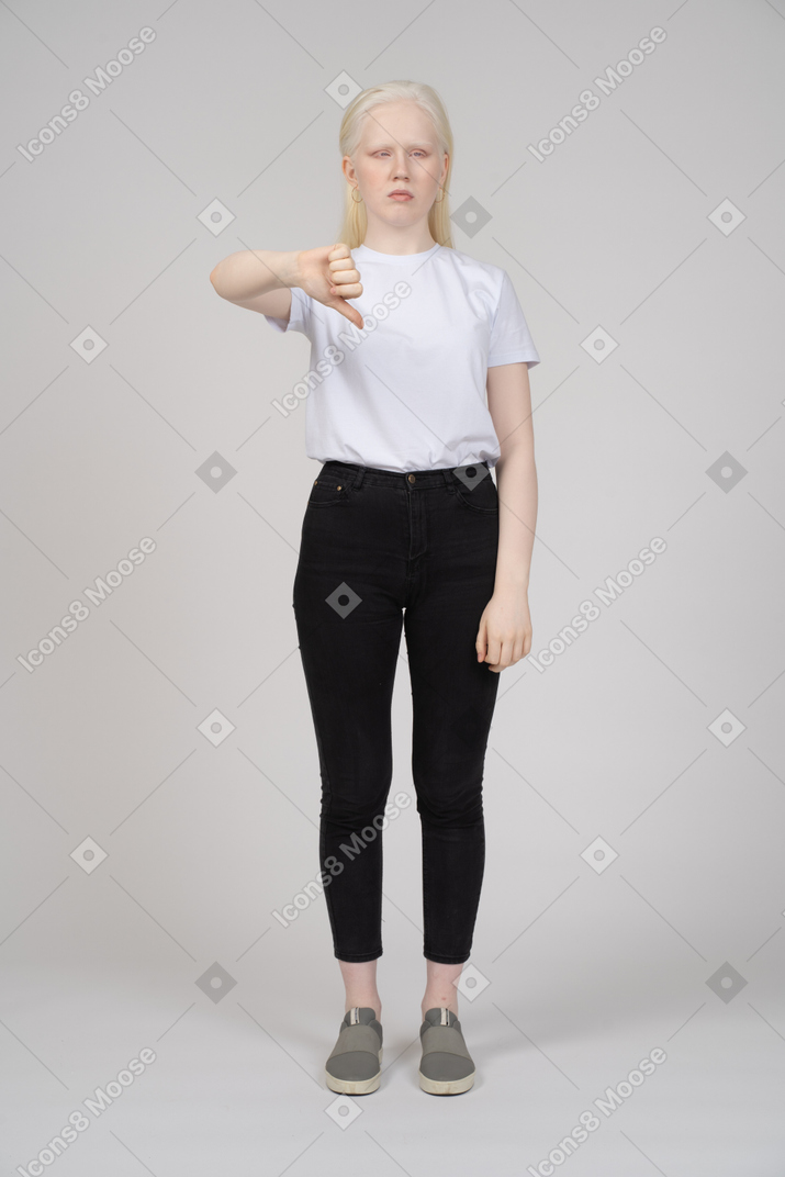 Front view of a young girl standing with thumbs down