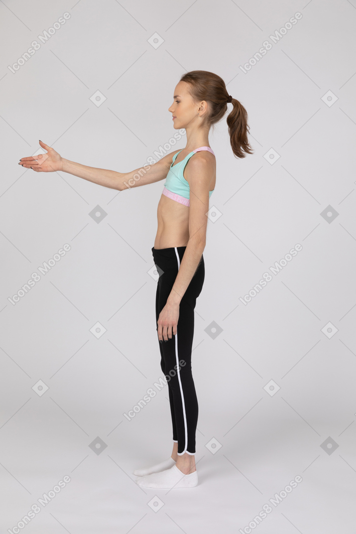 Side view of teen girl holding out her hand for handshake
