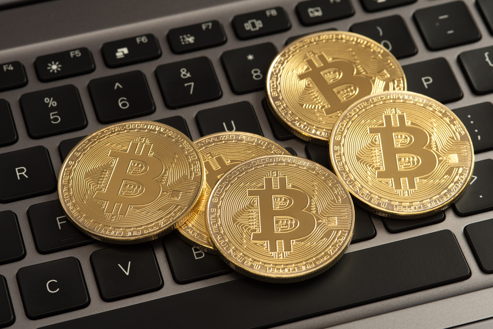 Bitcoins on laptop keyboard