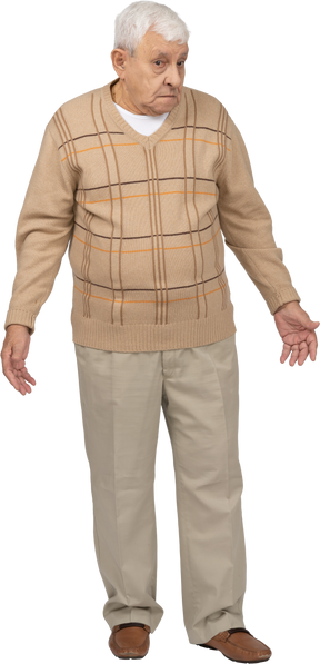 Vista frontale di un vecchio confuso in abiti casual in piedi con le braccia tese