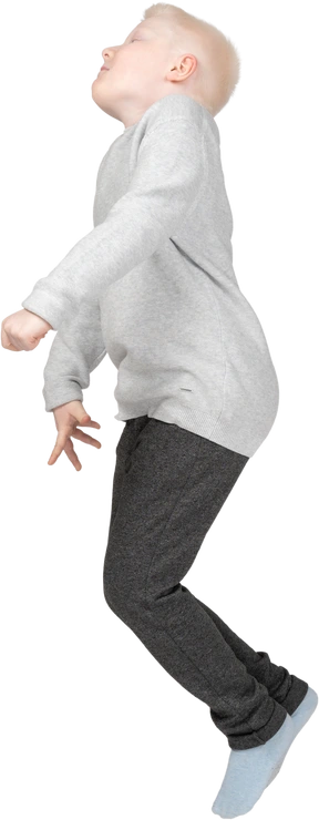 Side view of a boy jumping mid-air