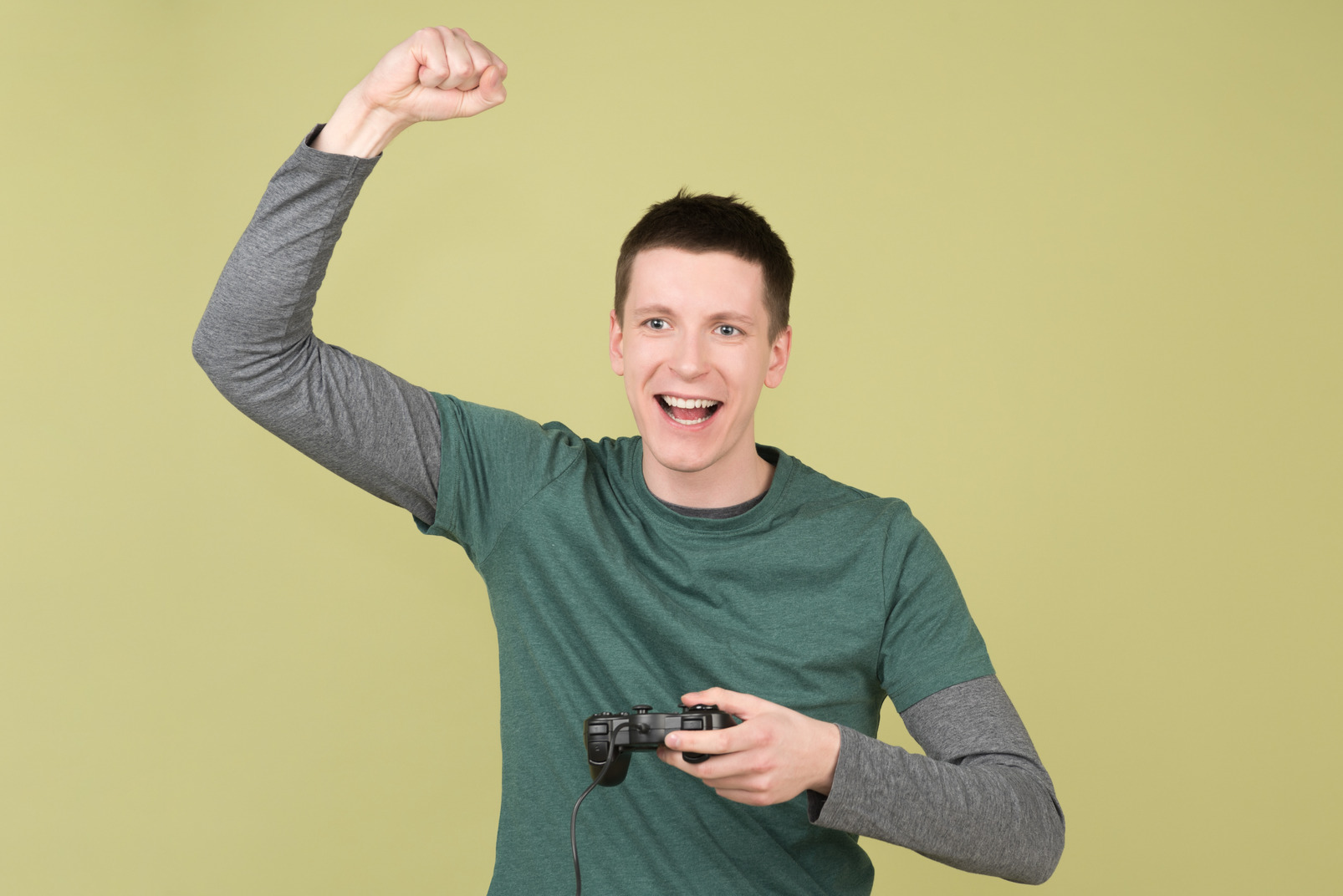 Happy and excited young man holding a joystick