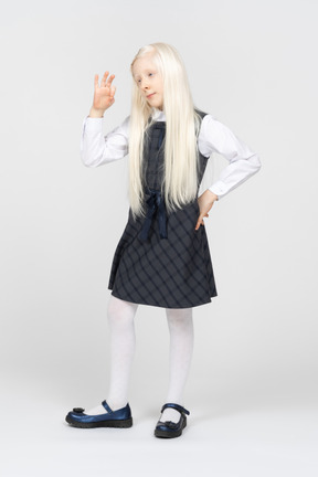 Schoolgirl making okay sign