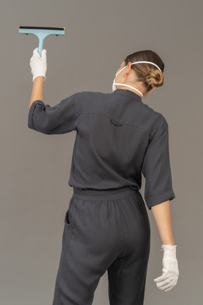 Back view of a woman with a window-cleaning tool