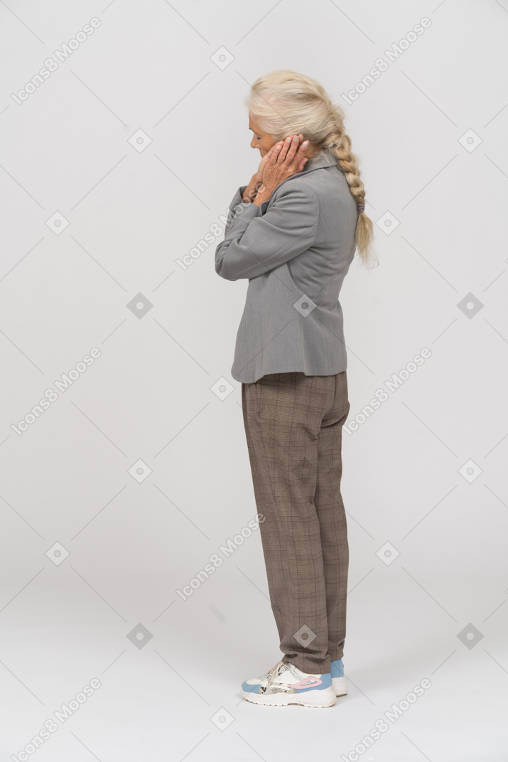 Side view of a sleepy old lady in suit