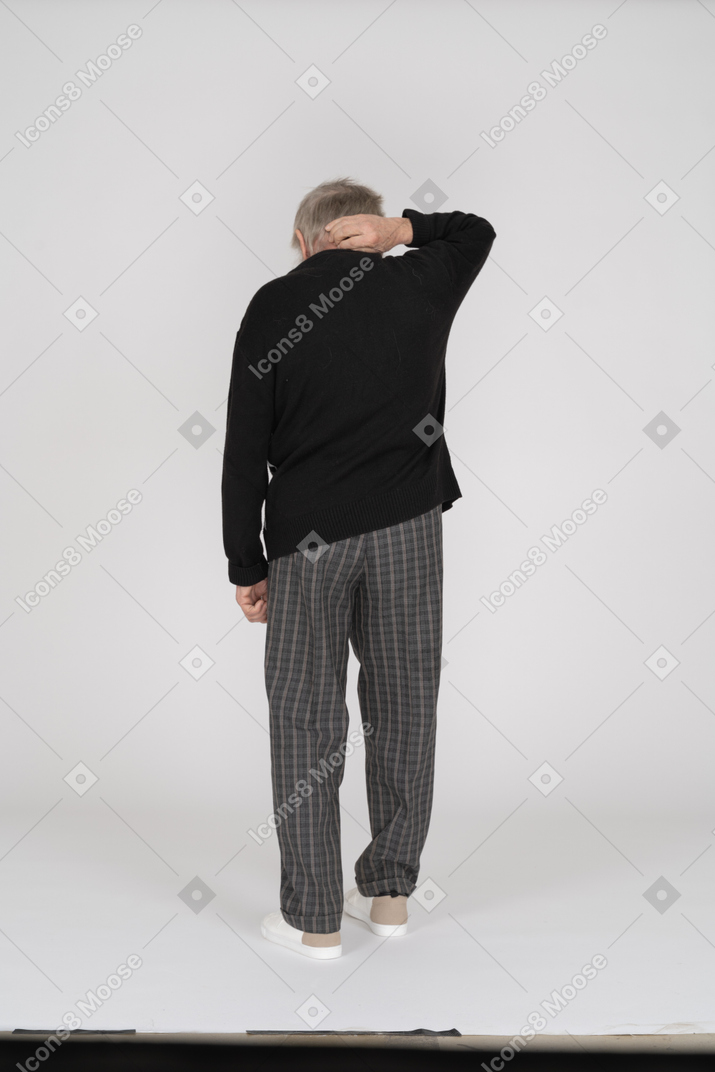Back view of old man holding neck