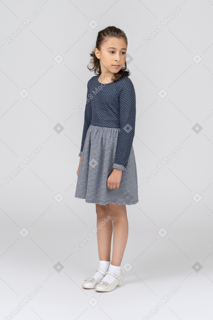 Front view of a girl standing with her head turned