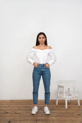 Front view of woman standing with hands in pockets
