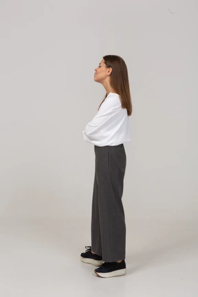 Side view of a suspicious young lady in office clothing looking aside