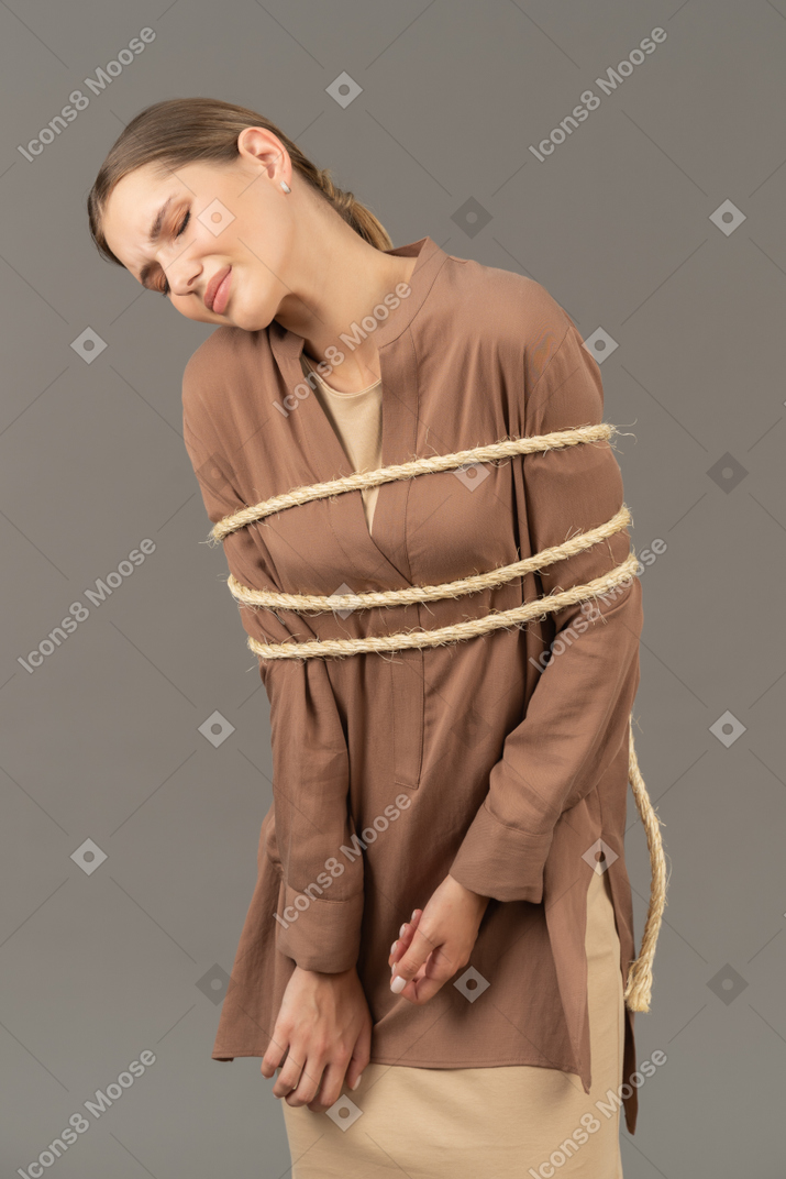 Young tied up woman leaning her head