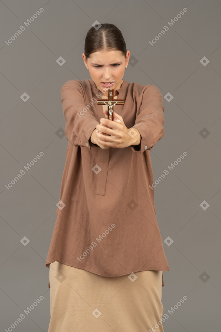 Young christian lady hold a cross in front of her