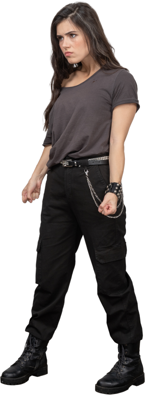 Three-quarter view of a female rocker clenching fists for self defense