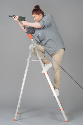 Young woman getting ready to drill