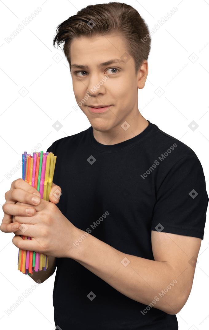 Shy teenager holds a pile of plastic straws