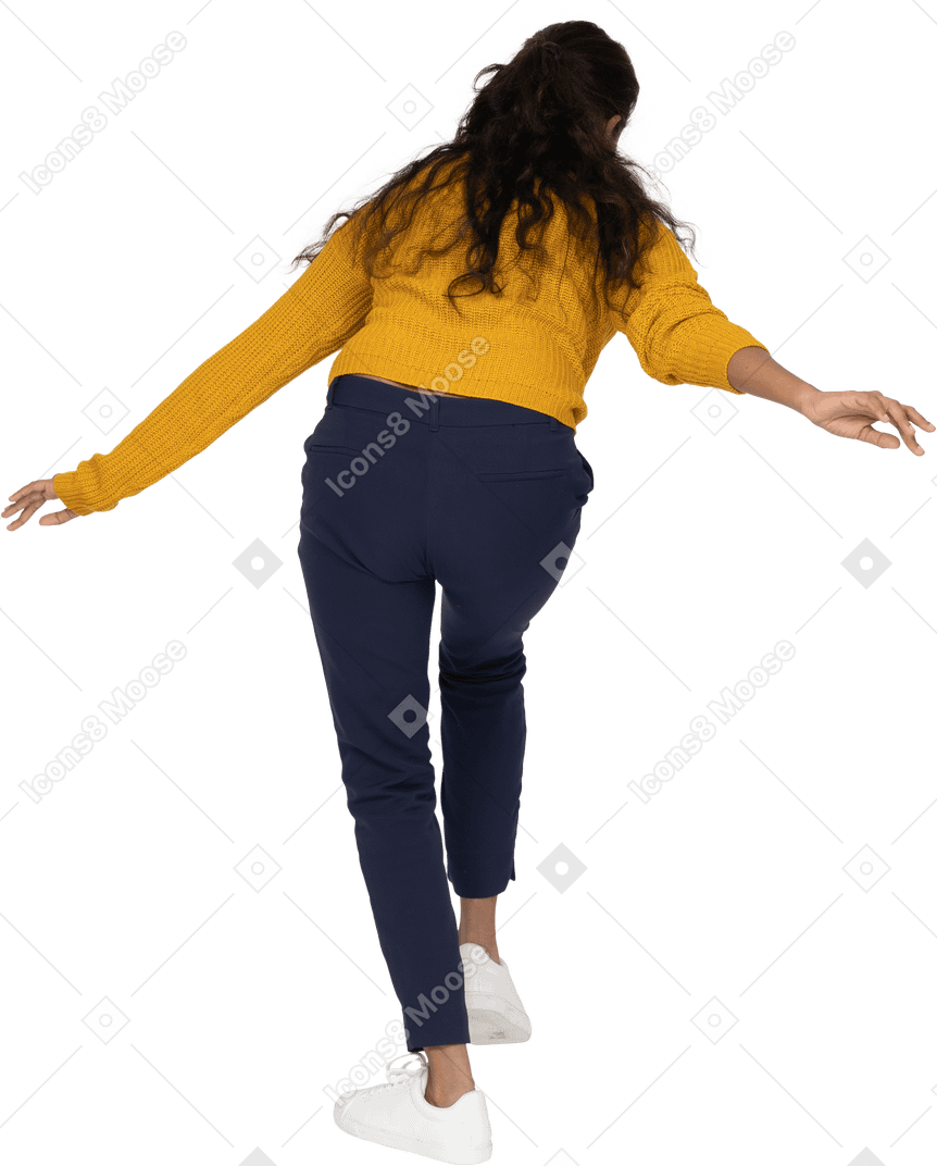 Rear view of a girl in casual clothes bending down with outstretched arms