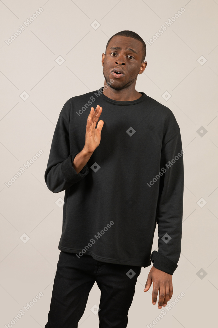 Worried man standing with raised hand