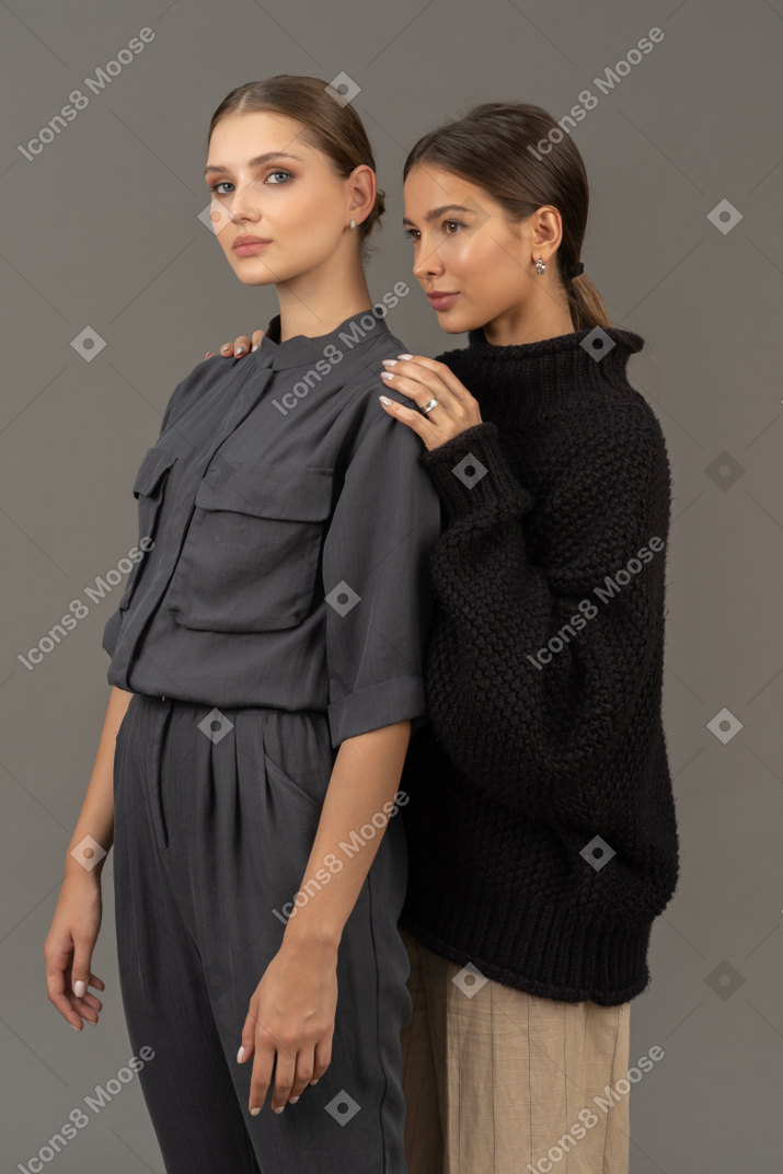 Two women standing one behind another