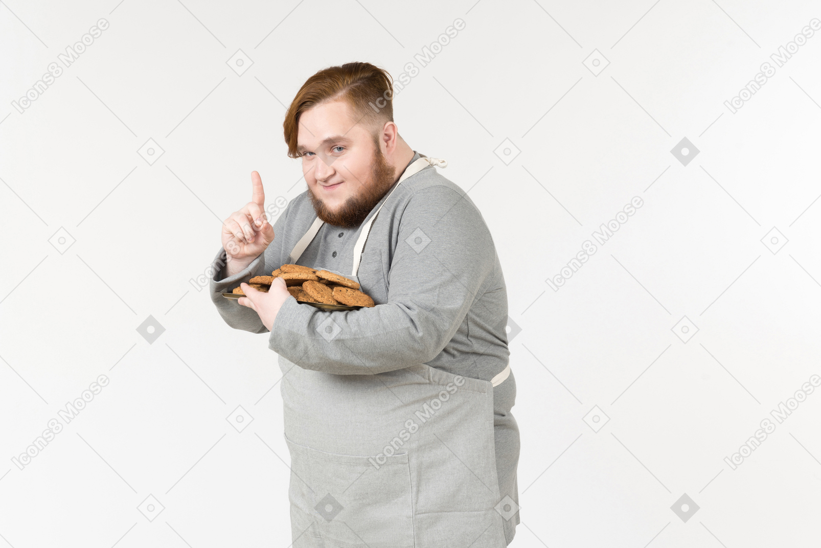 Looking cunning fat man with plate of cookies