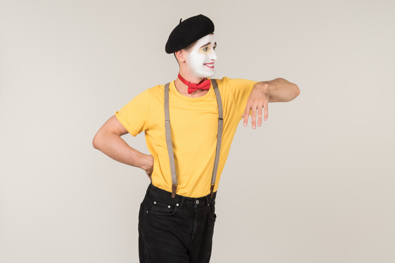Male mime leaning on invisible object