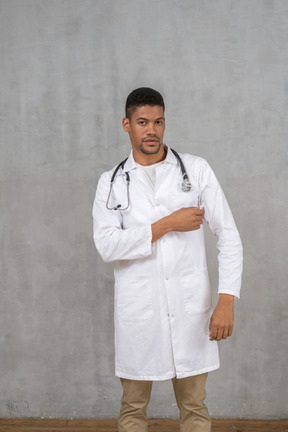 Male doctor touching his coat's pocket