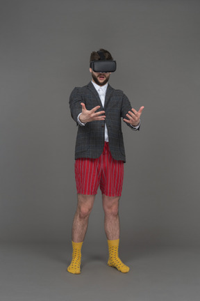 Man in vr headset is looking at his hands