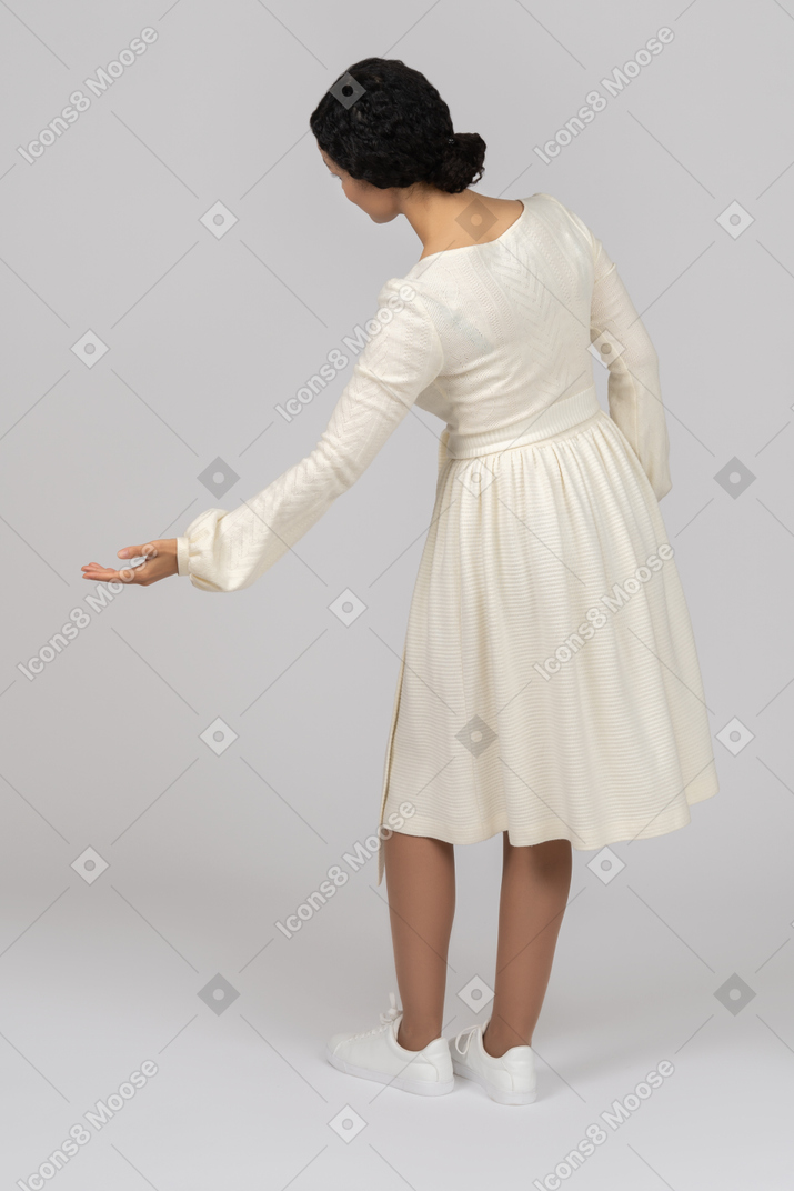 Young woman bowing for a curtsy backwards to camera