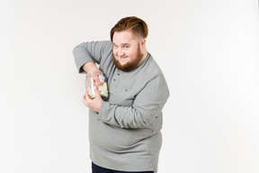 Big bearded man trying to reach marshmallows from the jar