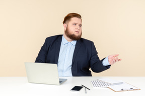 Young overweight office worker seems like asking something
