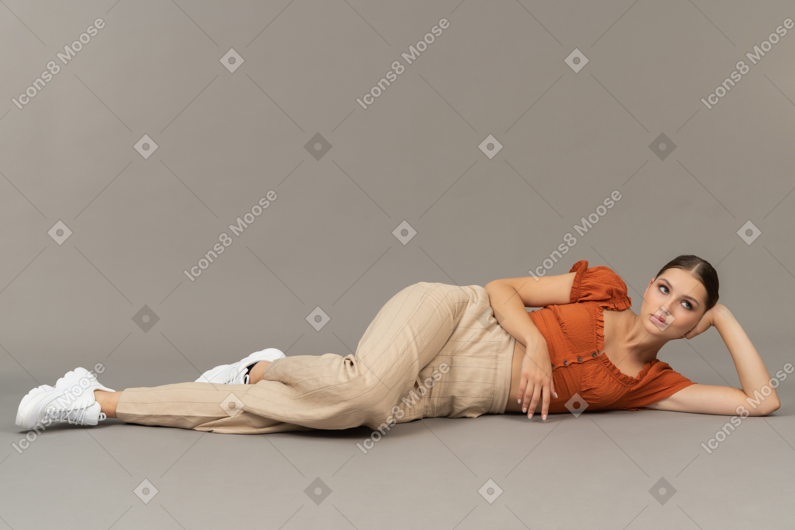 Young woman lying down and thinking