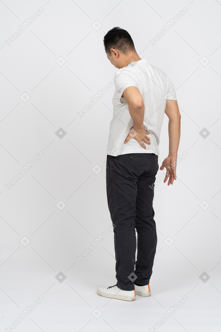 Three-quarter view of a man suffering from back pain