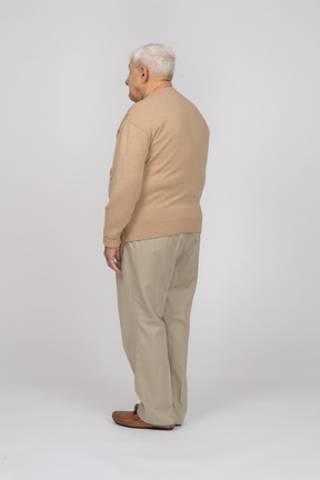 Side view of an old man un casual clothes standing still