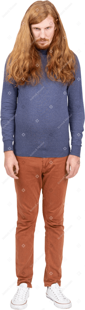 Serious young man in casual clothes looks at camera