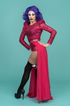 Drag queen in pink sequin dress posing with hands on hips