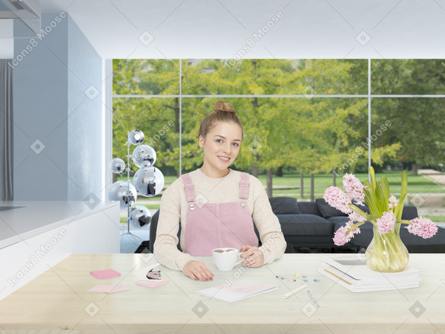 Pretty young woman in pink overalls drinking coffee in the middle of a modern-looking room among pink hyacinths and stationery
