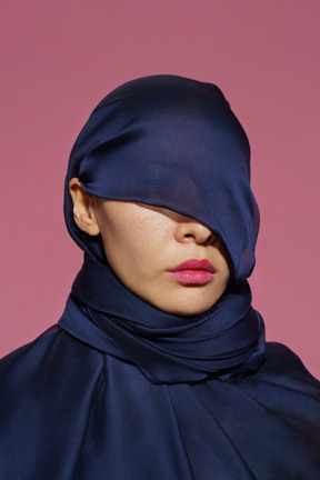 Close-up a young female wrapped in dark blue cloth