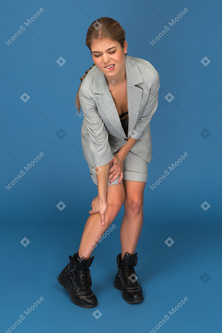 Young woman with leg ache