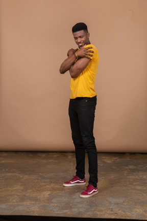 A man in a yellow shirt posing for a picture
