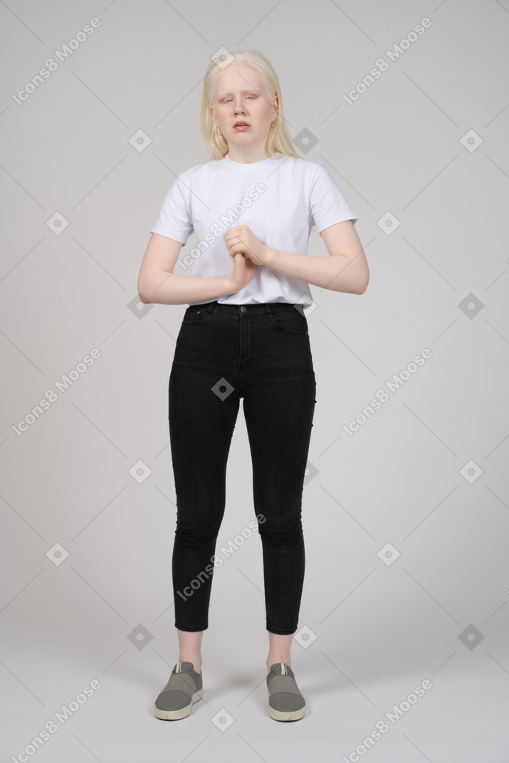 Standing young girl stretching a wrist