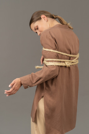 Side view of a tied woman