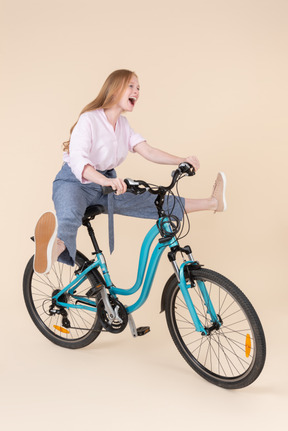 자전거를 타고 웃는 젊은 여자