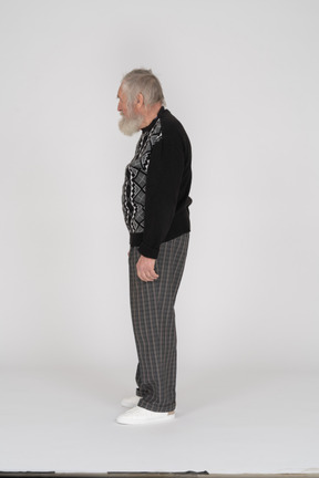 Side view of elderly man standing upright