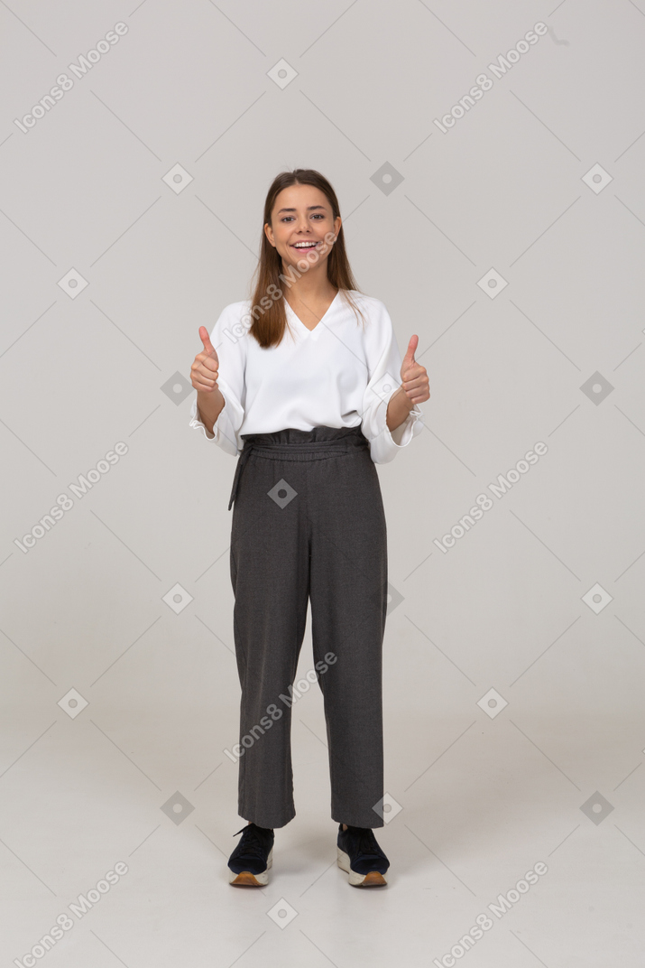 Front view of a young lady in office clothing showing thumbs up