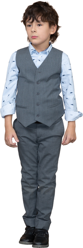 Front view of a boy in grey suit standing still