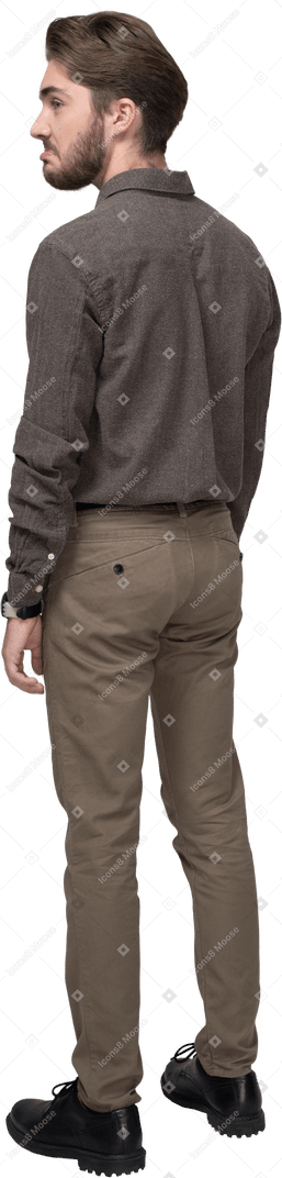 Three-quarter back view of a cute pouting man in office clothing