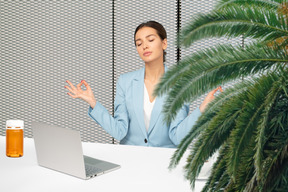 A woman sitting in front of a laptop computer