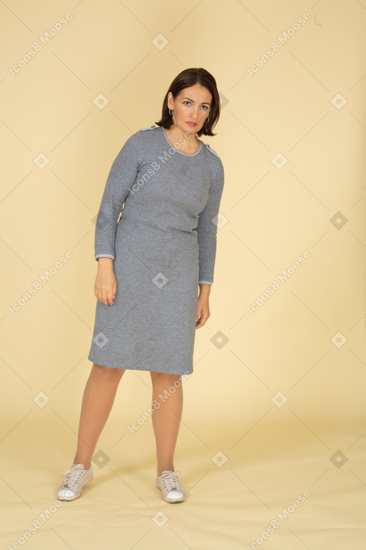 Front view of a sad woman in grey dress