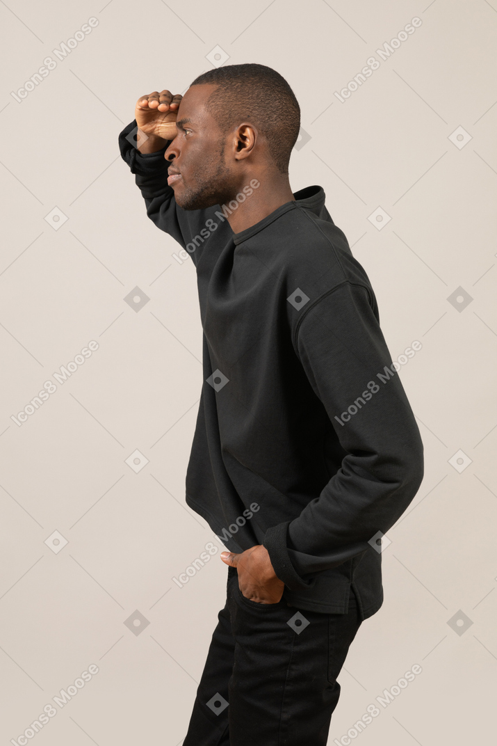 Side view of young man looking into distance