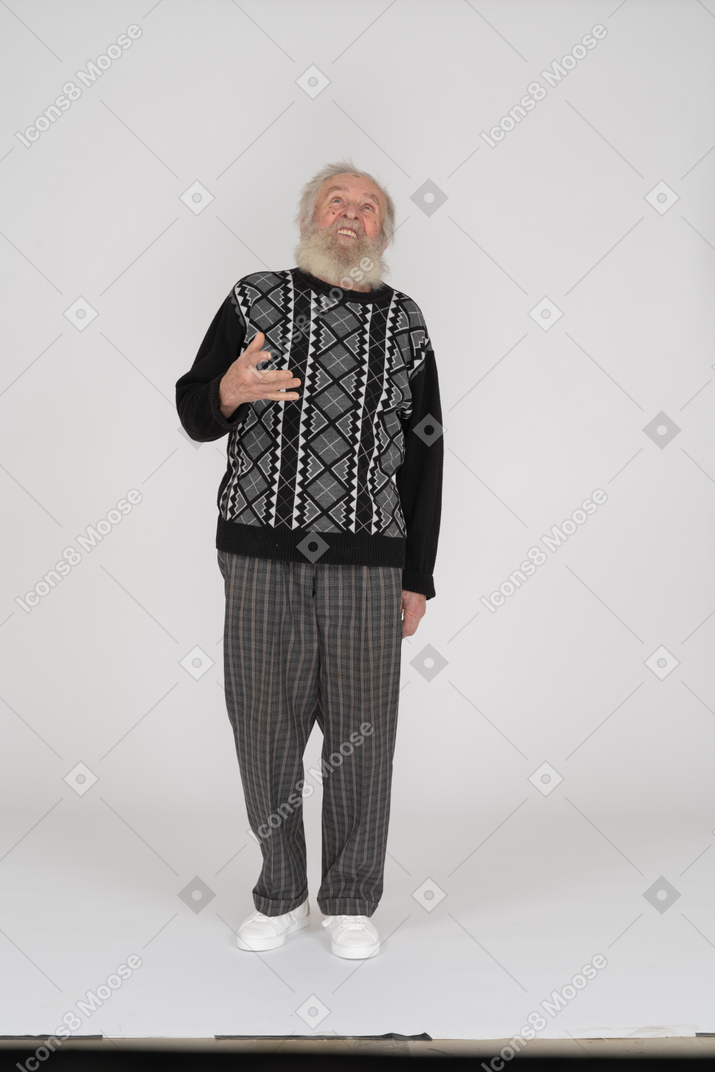 Old man talking and looking up with raised hand