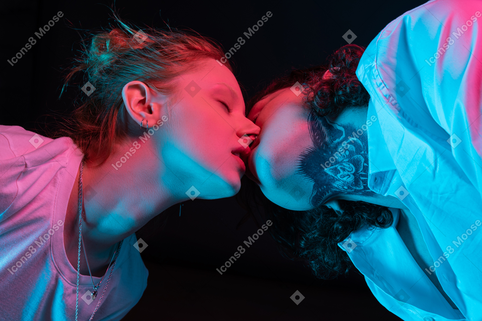 Close up a couple kissing in neon