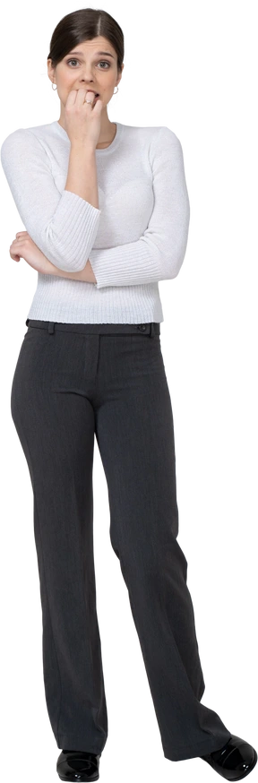 Front view of a perplexed young woman in office clothing